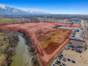 Birds eye view of property featuring a water and mountain view