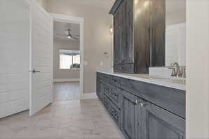 Bathroom featuring vanity and ceiling fan