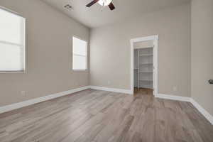 Unfurnished room with ceiling fan and light hardwood / wood-style flooring