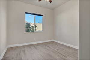 Spare room featuring light wood-type flooring and ceiling fan