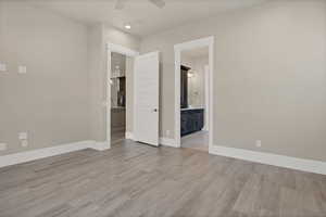 Empty room featuring light hardwood / wood-style flooring and ceiling fan