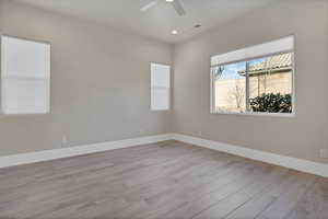 Unfurnished room with light hardwood / wood-style floors and ceiling fan