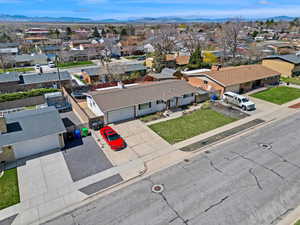 Birds eye view of property with a mountain view and a residential view