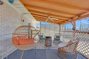View of patio with ceiling fan and an outdoor hangout area