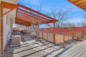 Wooden terrace featuring central AC, a fenced backyard, a pergola, and a patio area