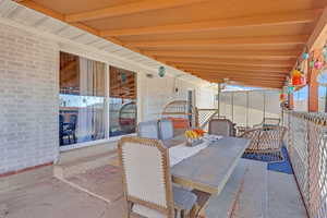 View of patio with ceiling fan and outdoor dining area