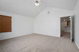 Bonus room featuring lofted ceiling, light colored carpet, and ceiling fan