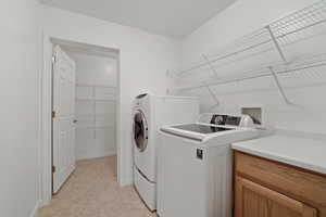 Laundry area with washer and clothes dryer