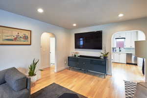 Living room featuring sink and light wood-type flooring