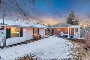 View of snow covered rear of property