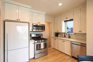 Kitchen featuring sink, appliances with stainless steel finishes, and light hardwood / wood-style flooring