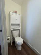 Bathroom featuring hardwood / wood-style floors and toilet