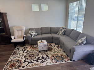 Living room with dark wood-type flooring