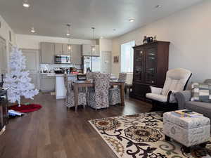 Living room with dark hardwood / wood-style flooring and a textured ceiling