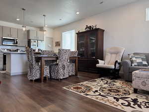 Dining area with dark hardwood / wood-style floors and a textured ceiling