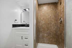 Bathroom with a tile shower and vanity