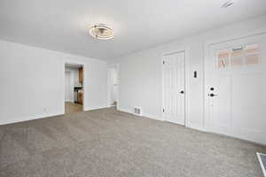 Unfurnished bedroom featuring carpet and a textured ceiling