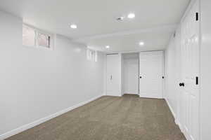 Basement with carpet flooring and a wealth of natural light