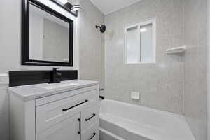 Bathroom with vanity and tiled shower / bath