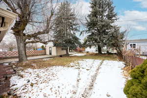 Snowy yard with a storage unit