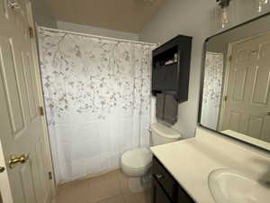 Bathroom featuring tile patterned flooring, vanity, and toilet