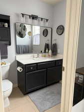 Bathroom featuring tile patterned floors, toilet, and vanity