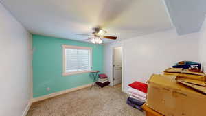 Interior space featuring light carpet and ceiling fan