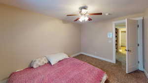 Carpeted bedroom with ceiling fan