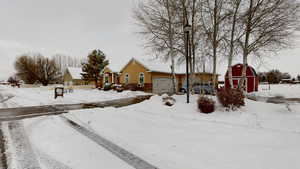 Snowy yard featuring a garage