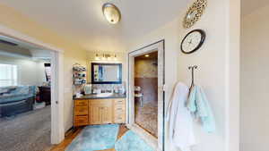 Bathroom with vanity and tiled shower