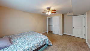 Bedroom with carpet, a closet, and ceiling fan