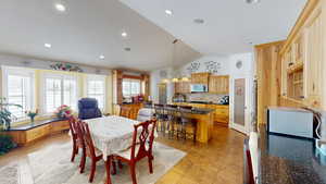 Dining space featuring vaulted ceiling