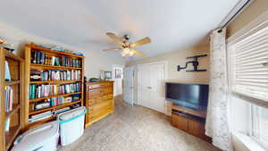 Interior space with ceiling fan and light colored carpet