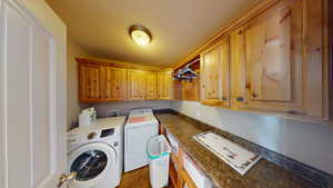 Washroom featuring washer and dryer and cabinets