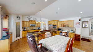 Tiled dining space with vaulted ceiling