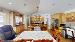 Tiled dining space with lofted ceiling