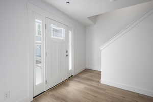 Entryway featuring baseboards and light wood-style floors