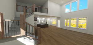 Interior space featuring hardwood / wood-style flooring and a towering ceiling