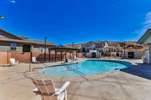 View of swimming pool with a patio and a pergola