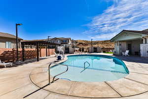 View of pool featuring a patio and a pergola