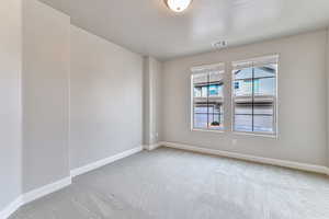 Unfurnished room featuring a textured ceiling and carpet flooring