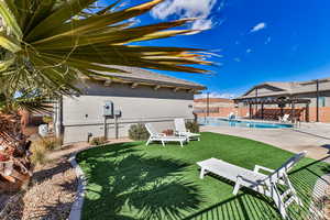 View of yard with a patio, a pergola, a gazebo, and a fenced in pool