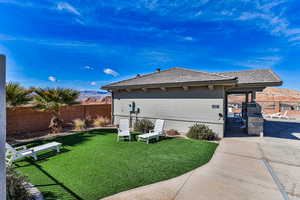 Exterior space featuring a lawn and a patio area