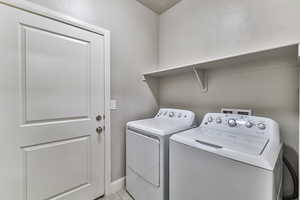 Washroom featuring washing machine and dryer