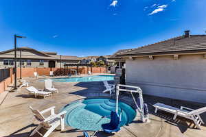 View of swimming pool with a community hot tub