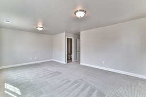 Spare room with carpet and a textured ceiling