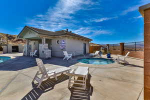 View of swimming pool with a patio area and a community hot tub