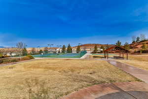 Surrounding community with tennis court, a yard, and a gazebo