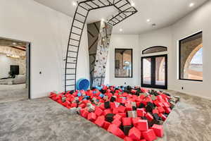 Entrance foyer with french doors and carpet flooring