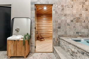 Bathroom with tile walls and wood ceiling